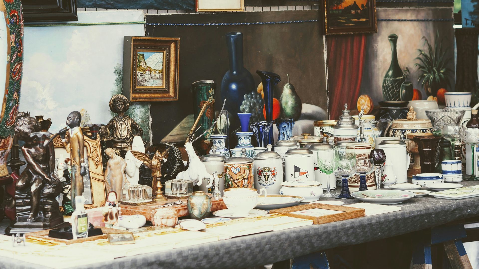 a table topped with lots of different types of vases