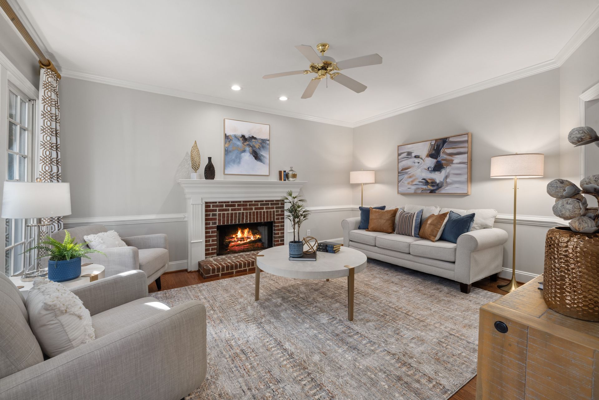A cozy modern living room featuring a fireplace, elegant sofa, and tasteful decor.